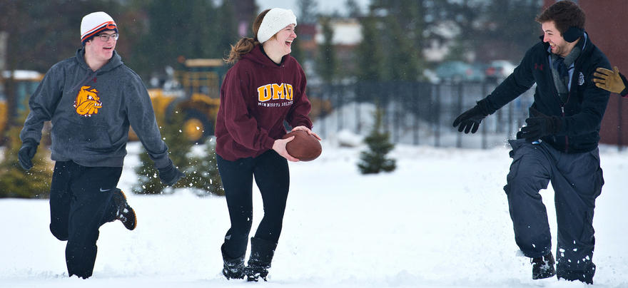 students playing football in the snow 