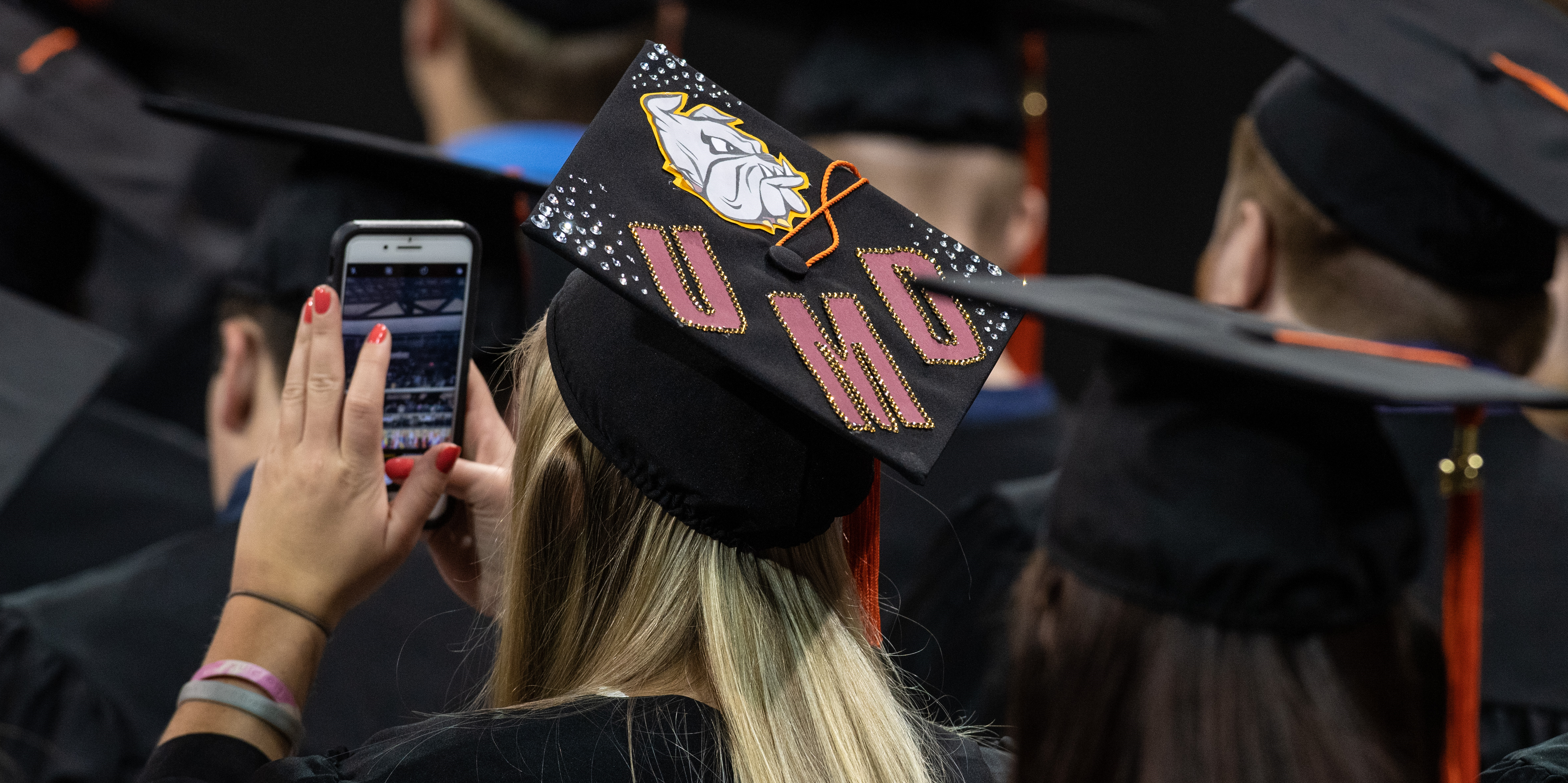 Student with UMD on their mortar board at commencement