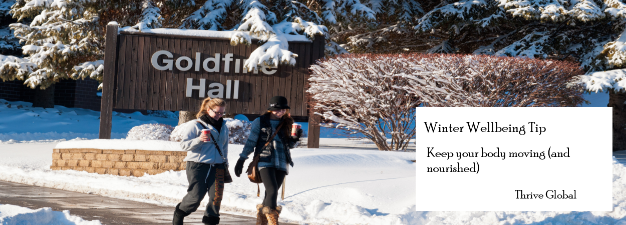 Students walking on campus near Goldfine Hall in winter